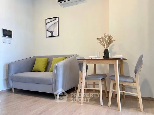 Modern living room with cozy gray sofa and stylish dining area