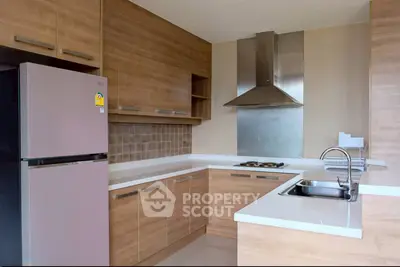 Modern kitchen with sleek wooden cabinets and stainless steel appliances