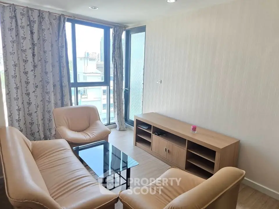 Bright living room with modern furniture and large window in a stylish apartment.