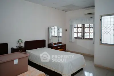 Spacious bedroom with natural light and classic furnishings