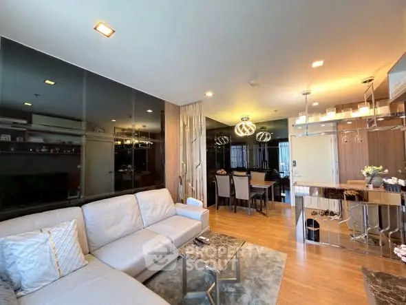 Luxurious open-plan living room with modern decor and elegant dining area