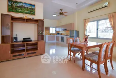Spacious open-plan living and dining area with modern kitchen and elegant furnishings.