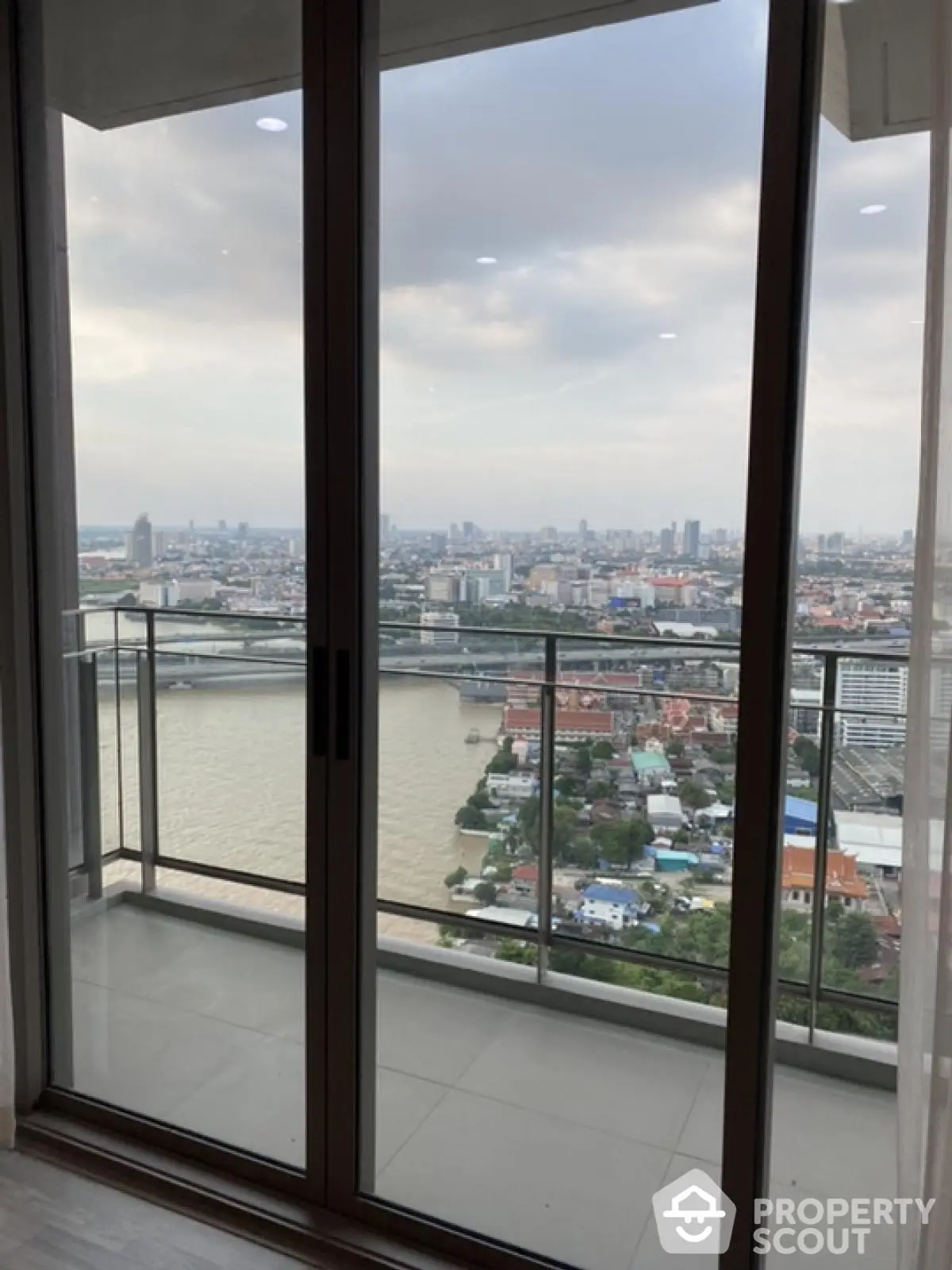 Stunning high-rise balcony view overlooking river and cityscape