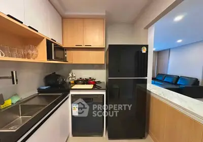 Modern kitchen with sleek black appliances and open layout