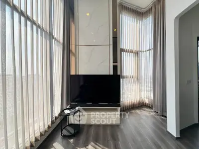 Luxurious high-ceiling living room with panoramic windows and modern decor