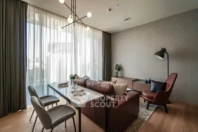 Stylish modern living room with elegant furniture and large window view
