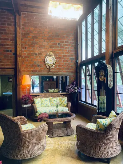 Charming rustic living room with wicker furniture and large windows