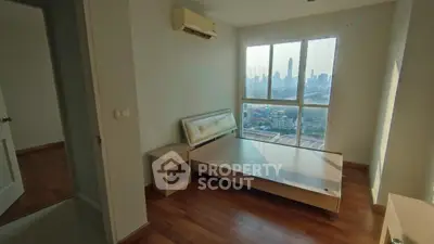 Spacious bedroom with stunning city view and wooden flooring in modern apartment