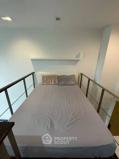 Cozy loft bedroom with modern railing and minimalist design