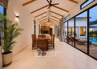Luxurious open-plan living area with pool view, featuring elegant wooden dining set and modern design.