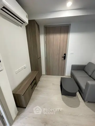 Modern living room with sleek furniture and air conditioning in a stylish apartment.