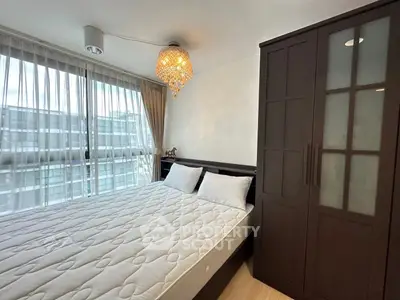 Modern bedroom with large window and elegant chandelier lighting