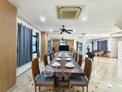 Spacious dining area with elegant table setting and open layout in luxurious home.