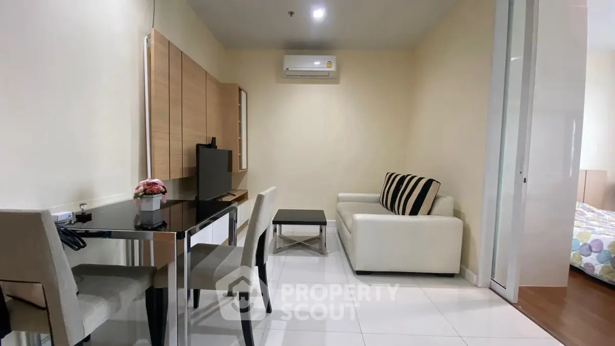 Modern living room with sleek furniture and air conditioning, perfect for cozy urban living.