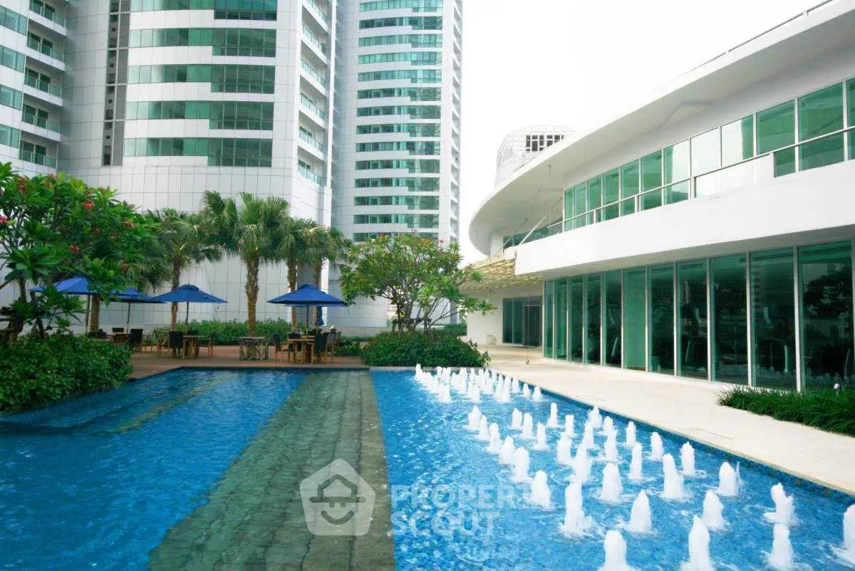Luxurious high-rise building with stunning pool and modern architecture.