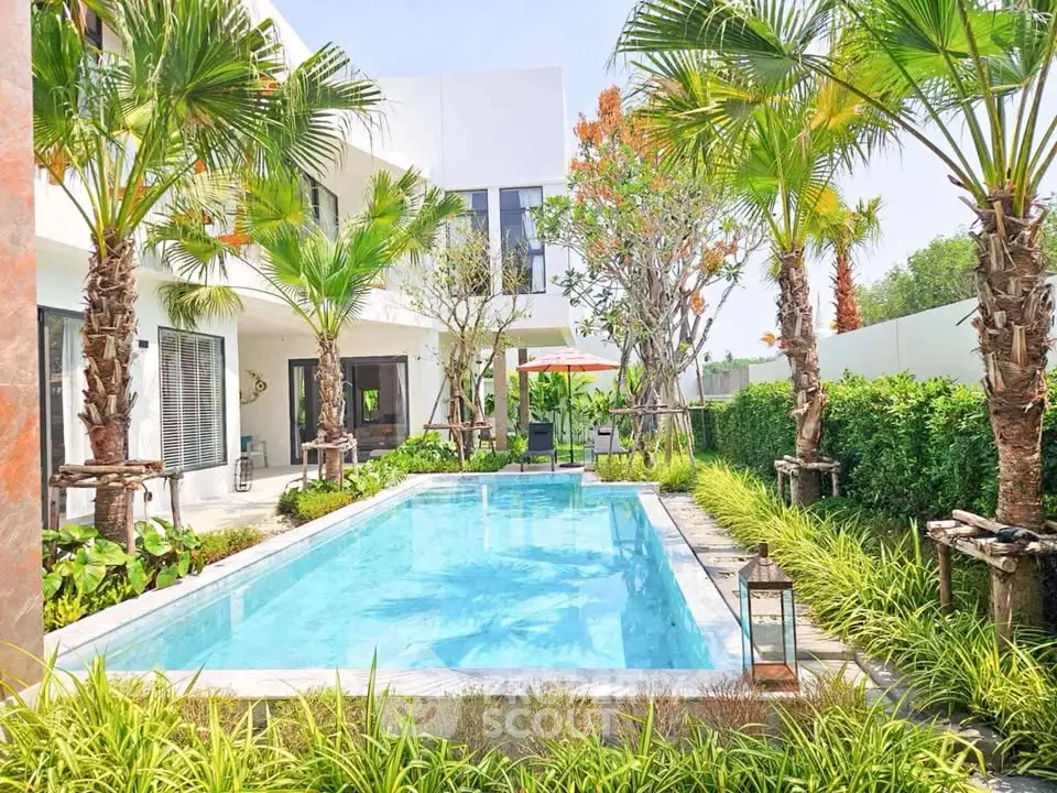 Luxurious modern villa with private pool and lush garden, perfect for relaxation and entertainment.