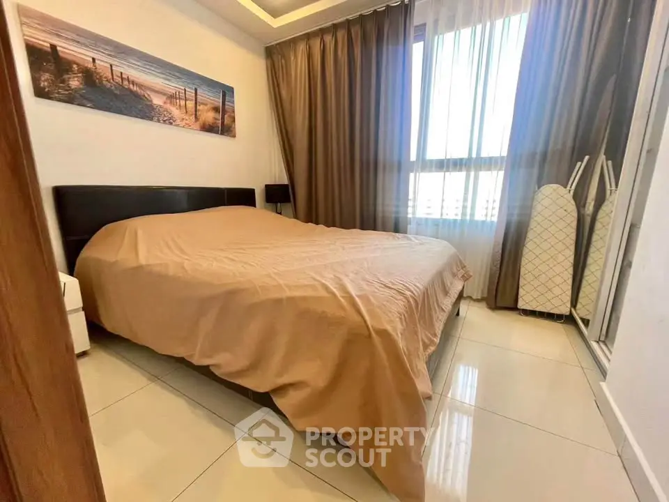 Cozy bedroom with large window and modern decor in a stylish apartment.