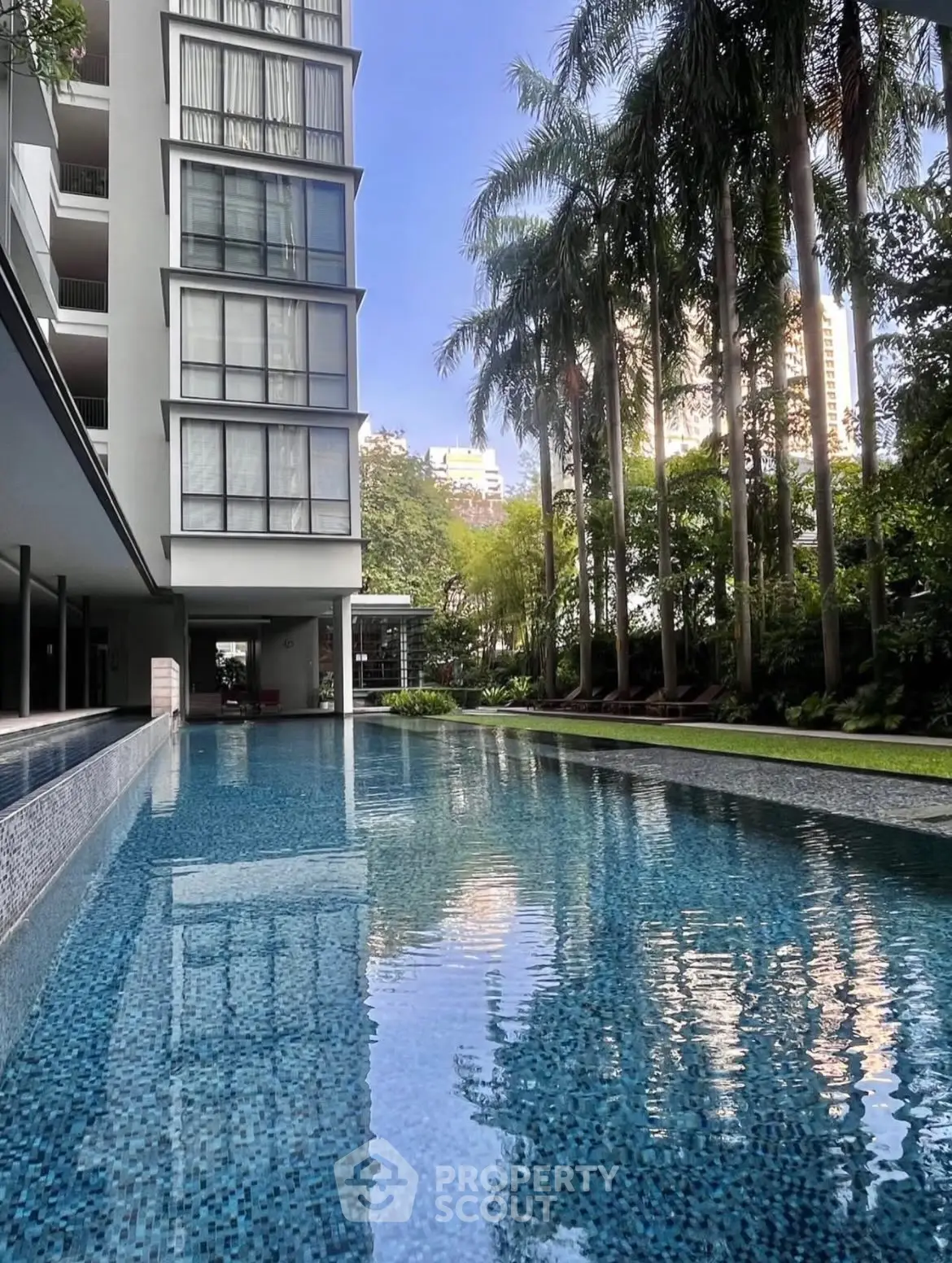 Luxurious condominium with stunning pool and lush greenery, perfect for relaxation and leisure.