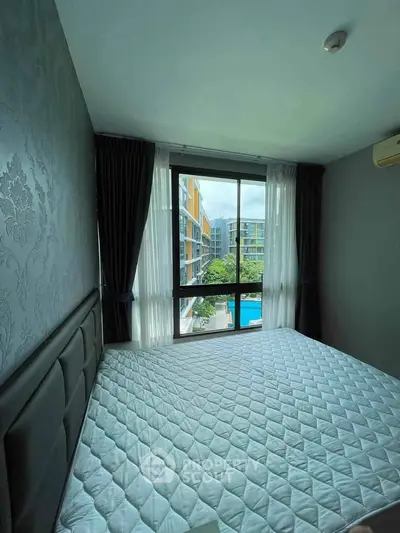 Modern bedroom with large window offering pool view in contemporary apartment