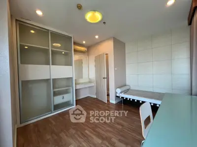 Modern bedroom with wooden flooring and built-in wardrobe