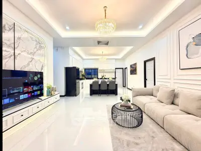 Luxurious open-layout living room with modern kitchen and elegant decor