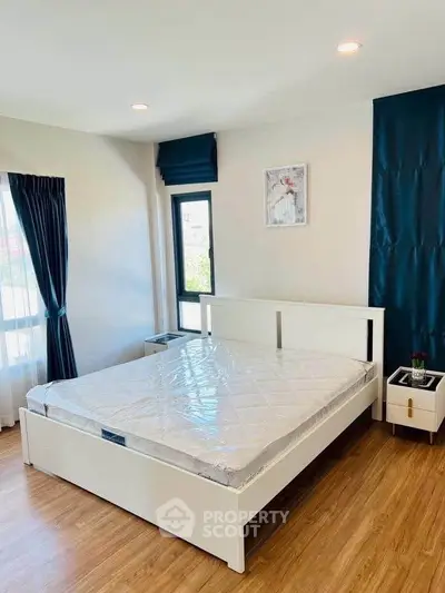 Modern bedroom with wooden flooring and stylish decor