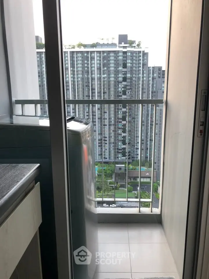 Modern apartment balcony with washing machine and city view