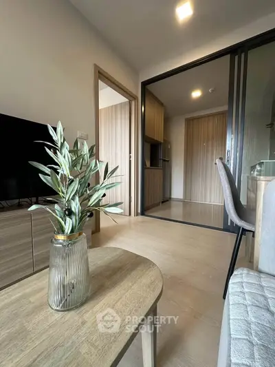 Modern living room with stylish decor and open view to kitchen area