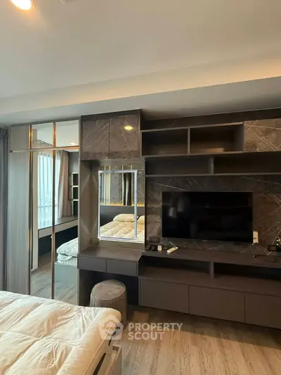 Modern bedroom with sleek built-in TV unit and luxurious decor