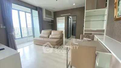 Modern living room with balcony and stylish furniture in a high-rise apartment.