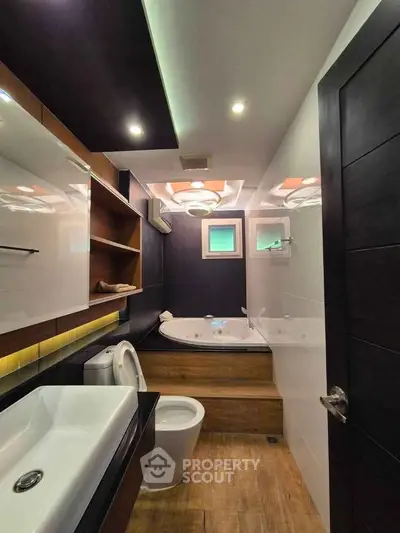 Luxurious modern bathroom with elegant fixtures and a spacious bathtub, perfect for relaxation.