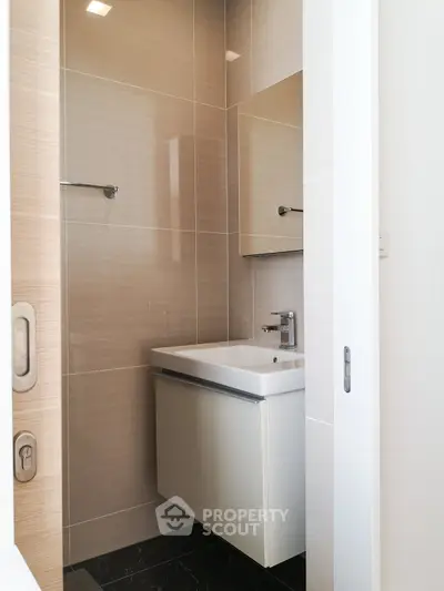 Modern minimalist bathroom with sleek sink and wall-mounted mirror
