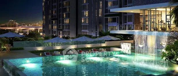 Luxurious apartment complex with illuminated pool and city view at night.