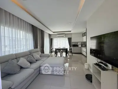 Spacious modern living room with open kitchen and sleek furnishings