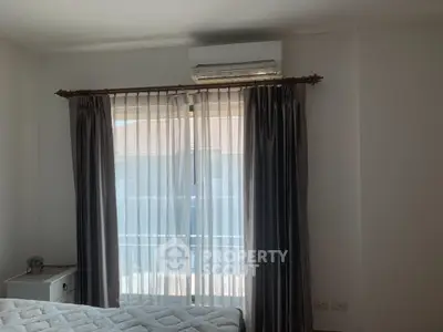 Cozy bedroom with natural light and elegant curtains