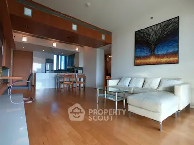 Spacious modern living room with open kitchen and elegant wooden flooring