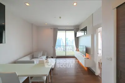Modern living room with city view, sleek furniture, and large windows in a high-rise apartment.
