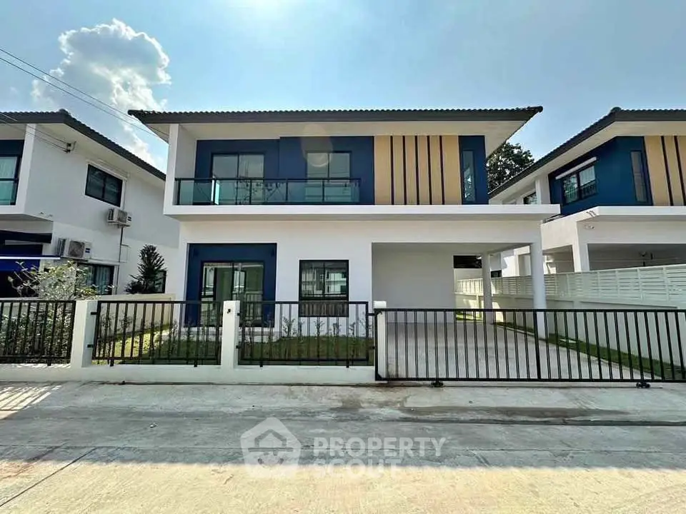 Modern two-story house with sleek design and spacious driveway in a serene neighborhood.