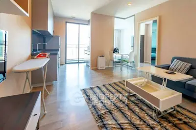 Modern living room with open kitchen and stylish decor in a bright apartment.