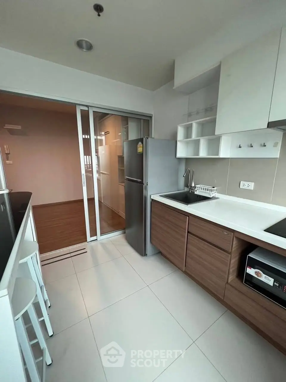 Modern kitchen with sleek cabinetry and stainless steel appliances in a compact layout.