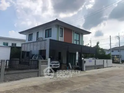 Modern two-story house with carport and contemporary design in a suburban neighborhood.
