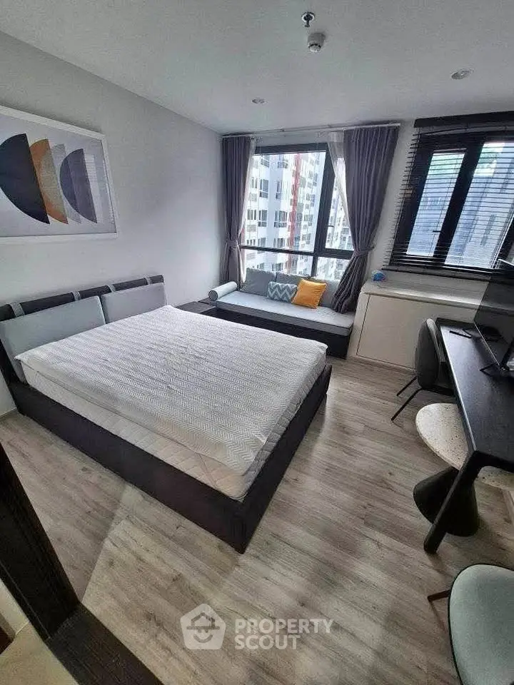 Modern bedroom with large window and stylish decor in urban apartment