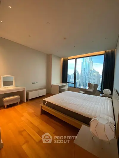 Spacious bedroom with city view in modern high-rise apartment