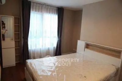 Cozy bedroom with natural light and modern furnishings, perfect for relaxation.