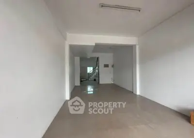 Spacious open-plan interior with tiled flooring and neutral walls, ideal for customization.