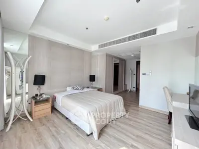 Spacious modern bedroom with elegant decor and natural light