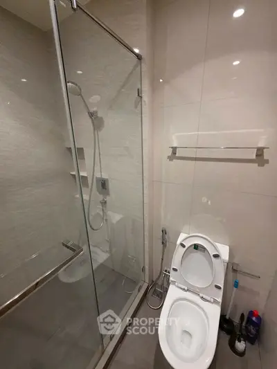 Modern bathroom with glass shower and sleek toilet design