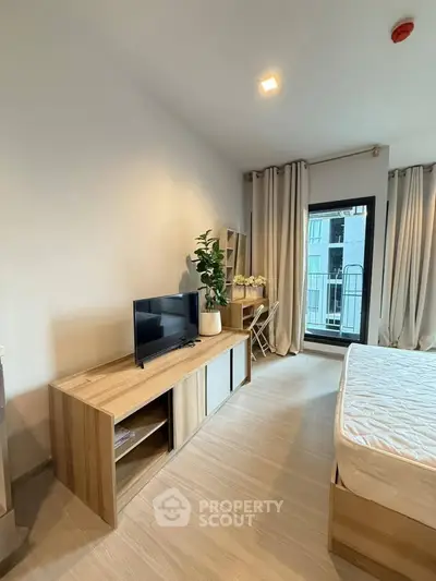 Modern bedroom with balcony access and stylish wooden furniture