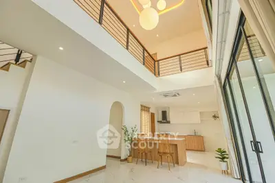 Spacious modern living area with high ceilings and open kitchen layout