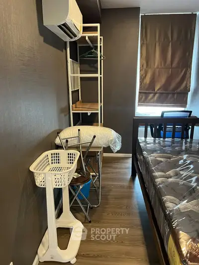 Cozy bedroom with air conditioning and modern furnishings, perfect for comfortable living.